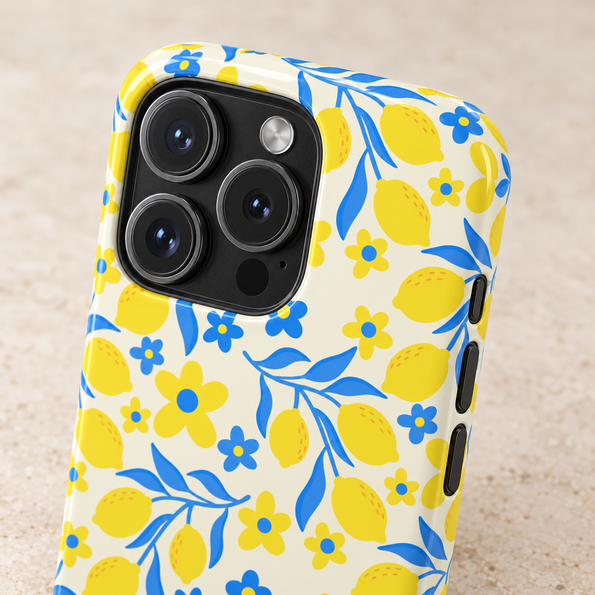 Amalfi Lemon phone case with card holder, yellow lemons and blue leaves on white, lifestyle close-up of the camera