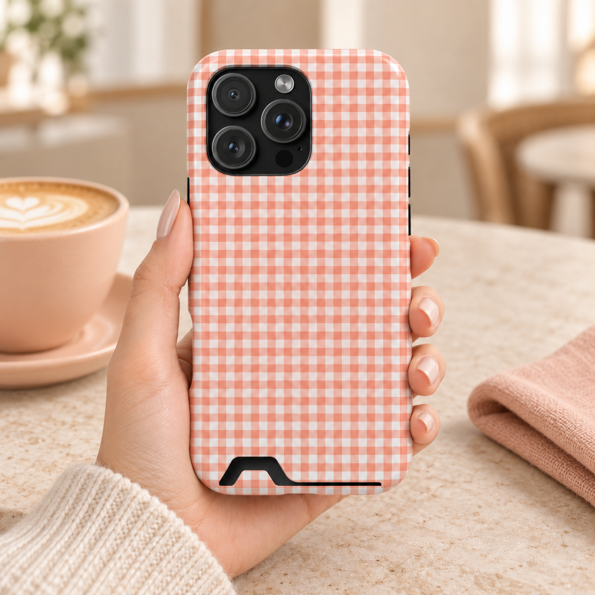 Peach Gingham phone case with card holder, peach gingham checks, lifestyle photo in hand with coffee