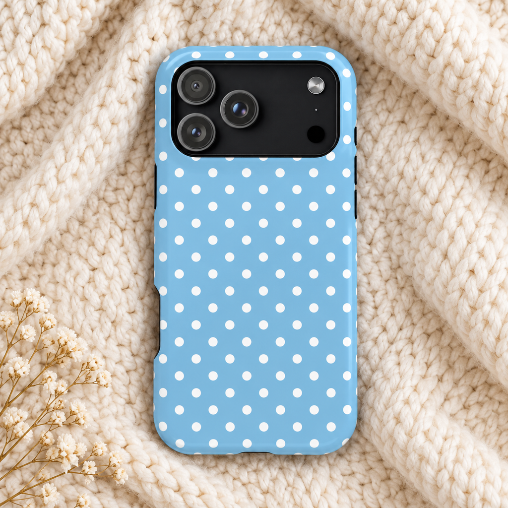 Baby Blue Polka Dot protective phone case, white polka dots on baby blue, lifestyle photo on a knit blanket