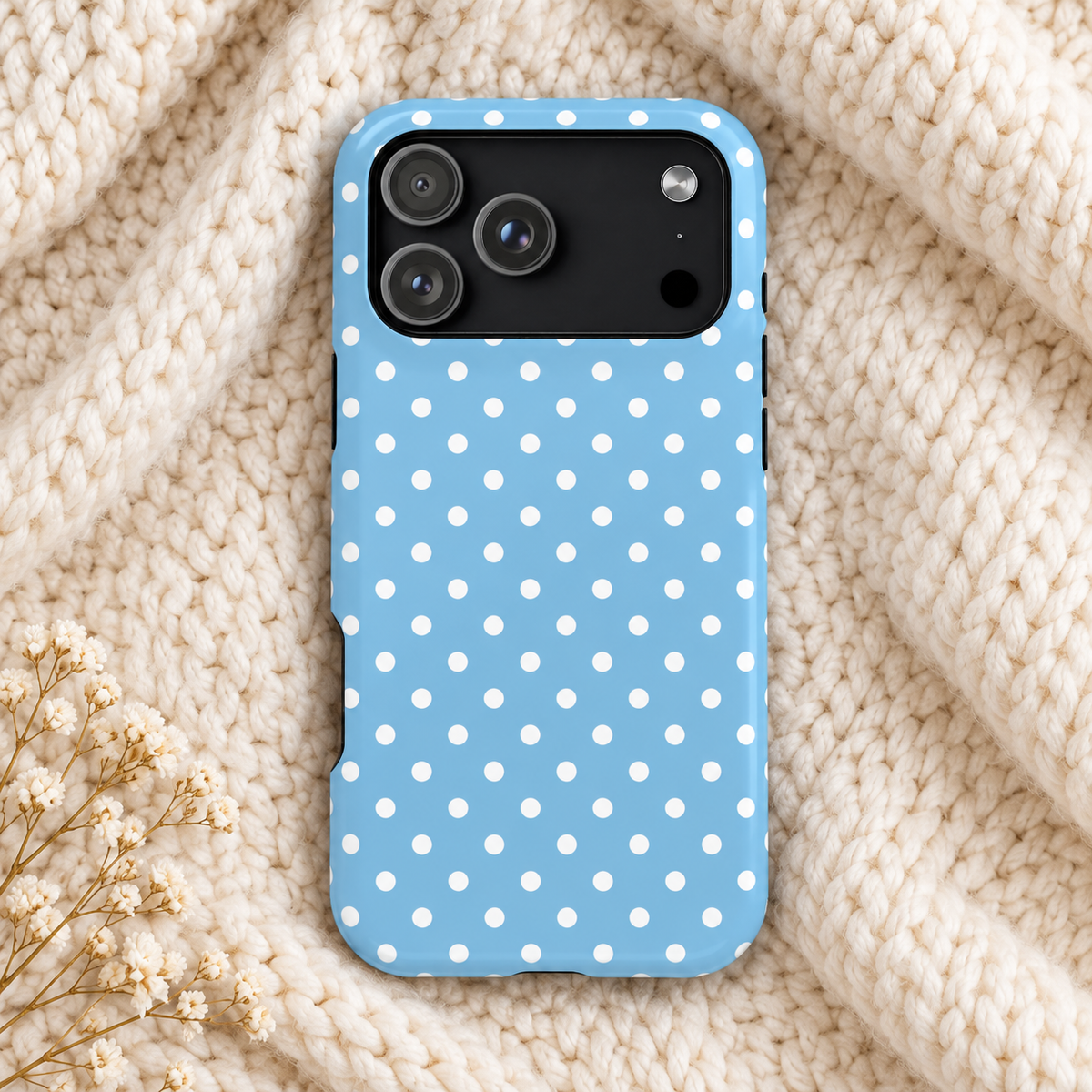 Baby Blue Polka Dot MagSafe case, white polka dots on baby blue, lifestyle photo on a knit blanket