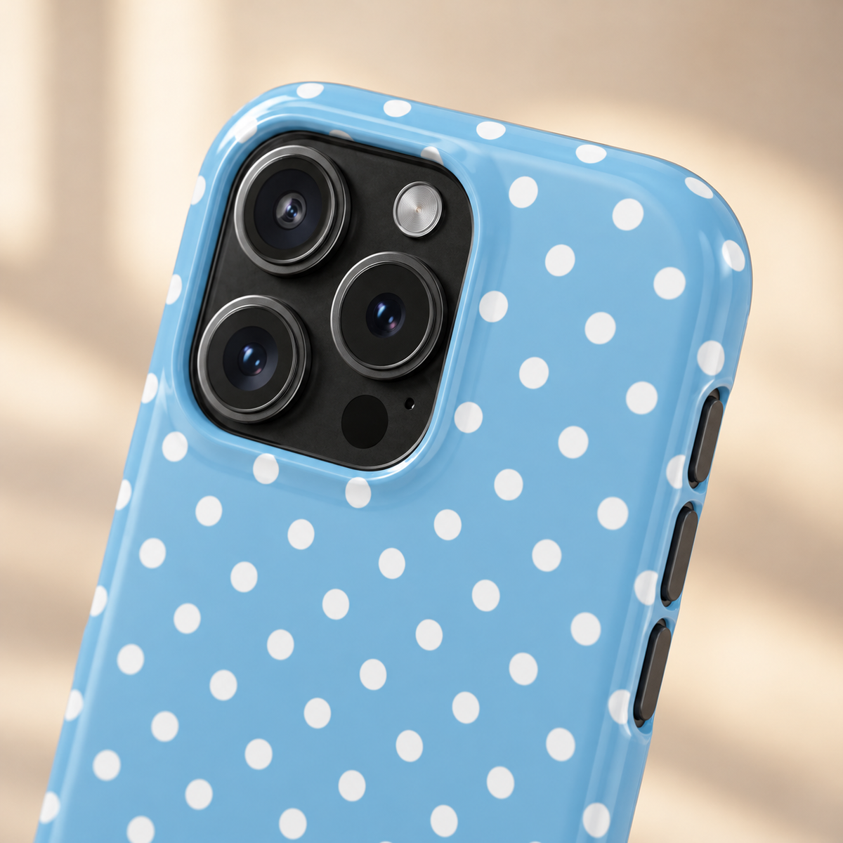 Baby Blue Polka Dot phone case with card holder, white polka dots on baby blue, lifestyle close-up of the camera