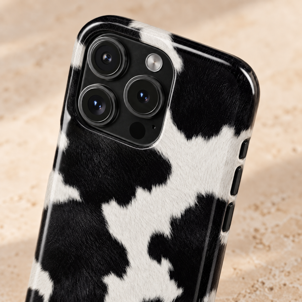 Black Cow Print protective phone case, black and white cow spots, lifestyle close-up of the camera