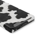 Black Cow Print phone case with card holder, close-up of the card slot