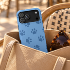 Blue Paw Print phone case with card holder, navy paw prints on cornflower blue, lifestyle photo in a handbag