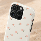 Blush Ditsy Floral MagSafe case, tiny blush blossoms on ivory, lifestyle close-up of the camera