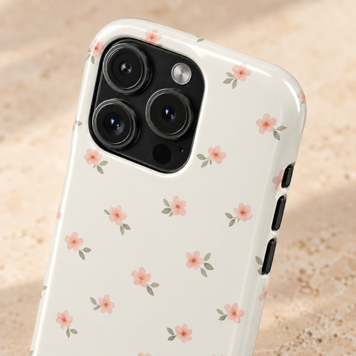 Blush Ditsy Floral MagSafe case, tiny blush blossoms on ivory, lifestyle close-up of the camera