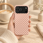 Blush Micro Dot protective phone case, tiny black dots on blush pink, lifestyle photo in hand with coffee