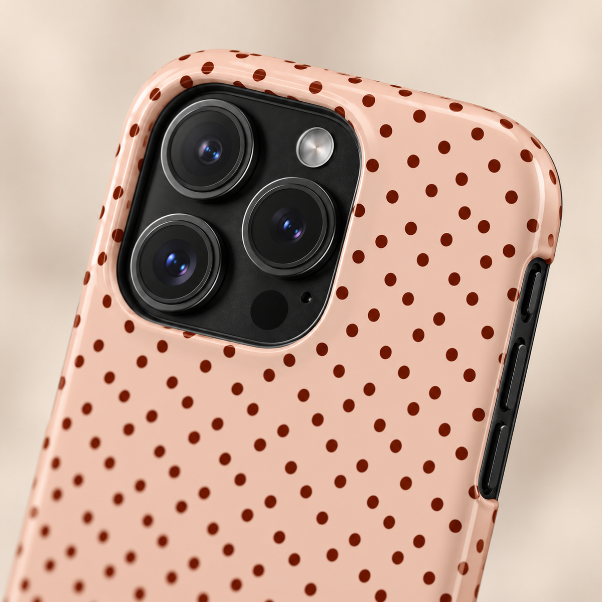 Blush Micro Dot protective phone case, tiny black dots on blush pink, lifestyle close-up of the camera