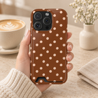 Brown Polka Dot phone case with card holder, soft pink polka dots on warm brown, lifestyle photo in hand with coffee