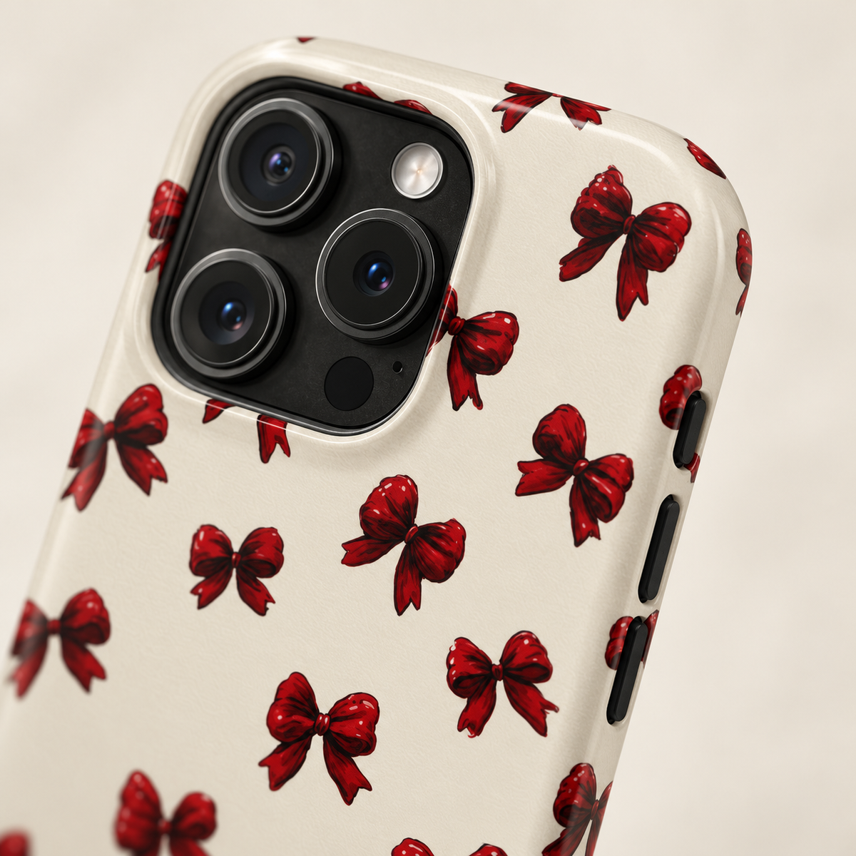 Burgundy Bow phone case with card holder, little burgundy bows on cream, lifestyle close-up of the camera