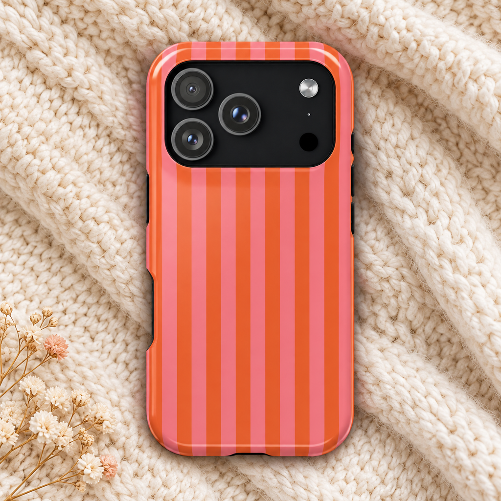 Cabana Stripe protective phone case, pink and orange stripes, lifestyle photo on a knit blanket