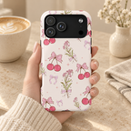 Cherry Bouquet MagSafe case, pink cherries, bows and flower sprigs on cream, lifestyle photo in hand with coffee