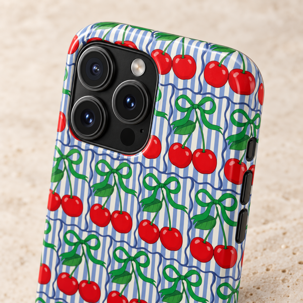 Cherry Bow Stripe protective phone case, red cherries and green bows on blue stripes, lifestyle close-up of the camera