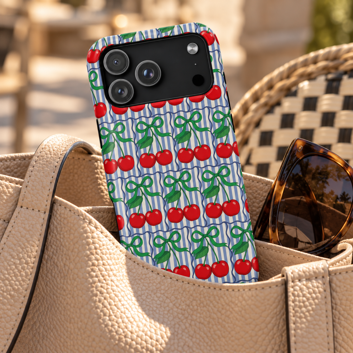 Cherry Bow Stripe phone case with card holder, red cherries and green bows on blue stripes, lifestyle photo in a handbag