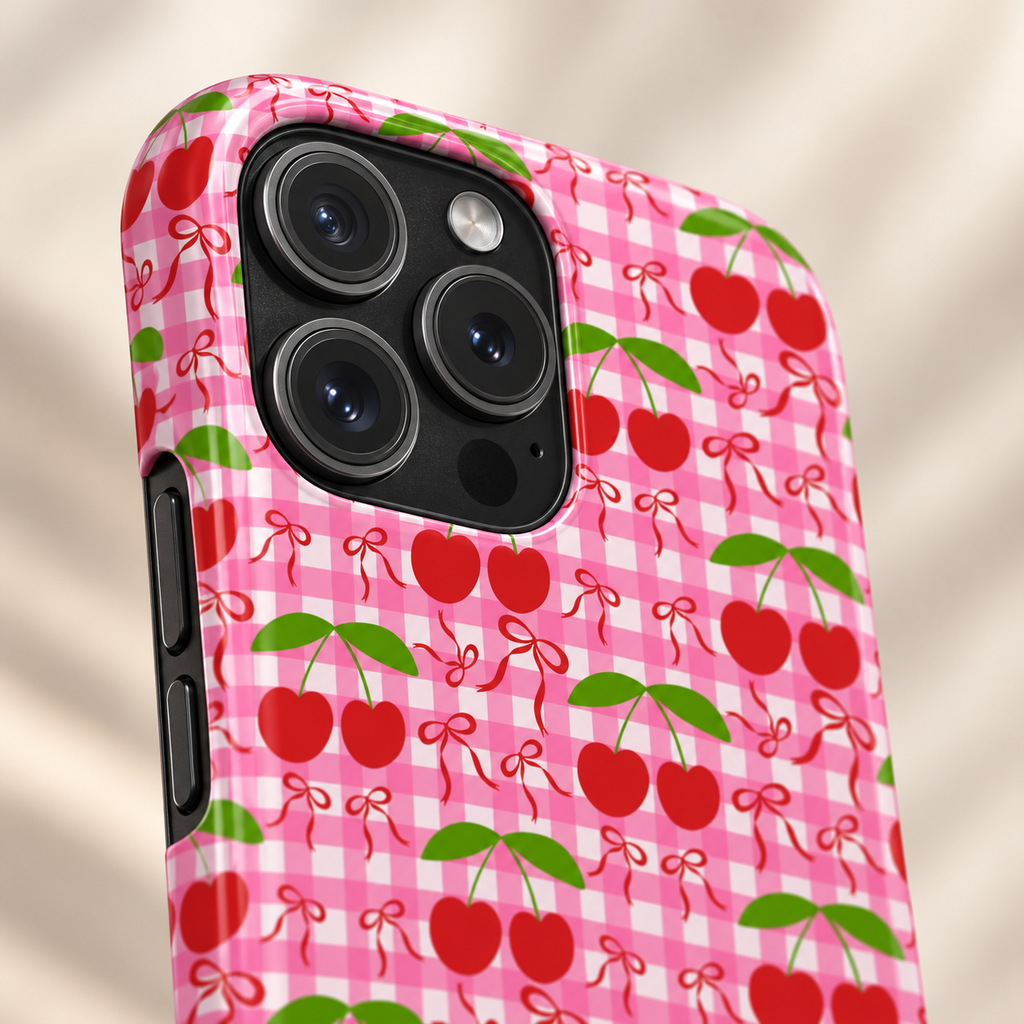 Cherry Gingham MagSafe case, red cherries on hot pink gingham, lifestyle close-up of the camera
