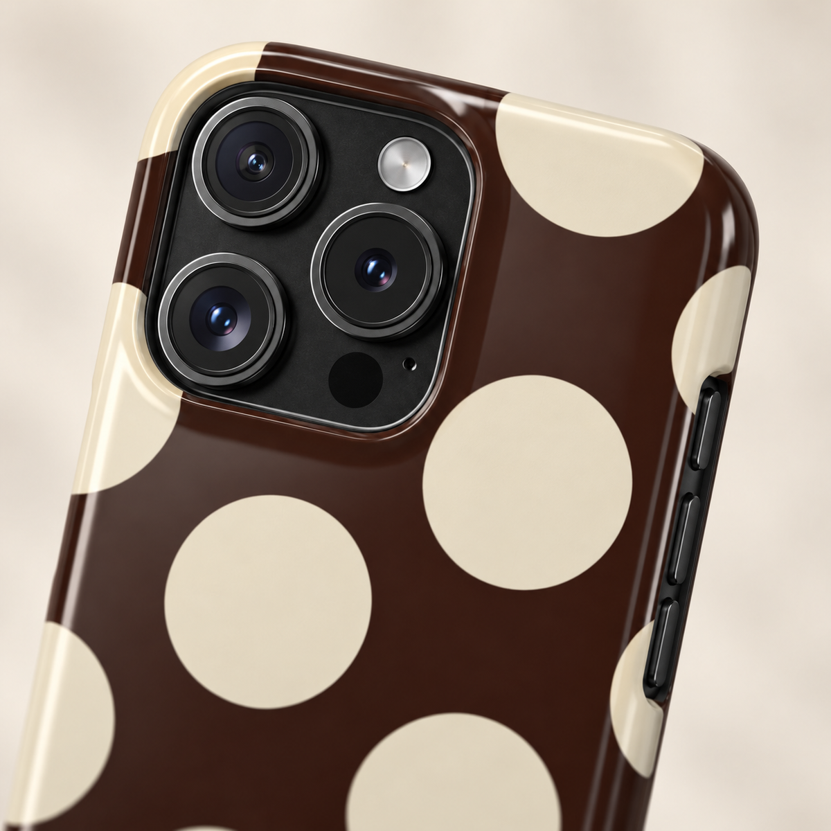 Chocolate Polka Dot protective phone case, big cream polka dots on dark chocolate, lifestyle close-up of the camera