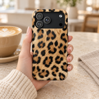 Classic Leopard protective phone case, classic tan and black leopard print, lifestyle photo in hand with coffee