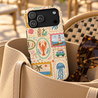 Coastal Postcard phone case with card holder, seaside stamps with jellyfish, lobsters and lighthouses, lifestyle photo in a handbag