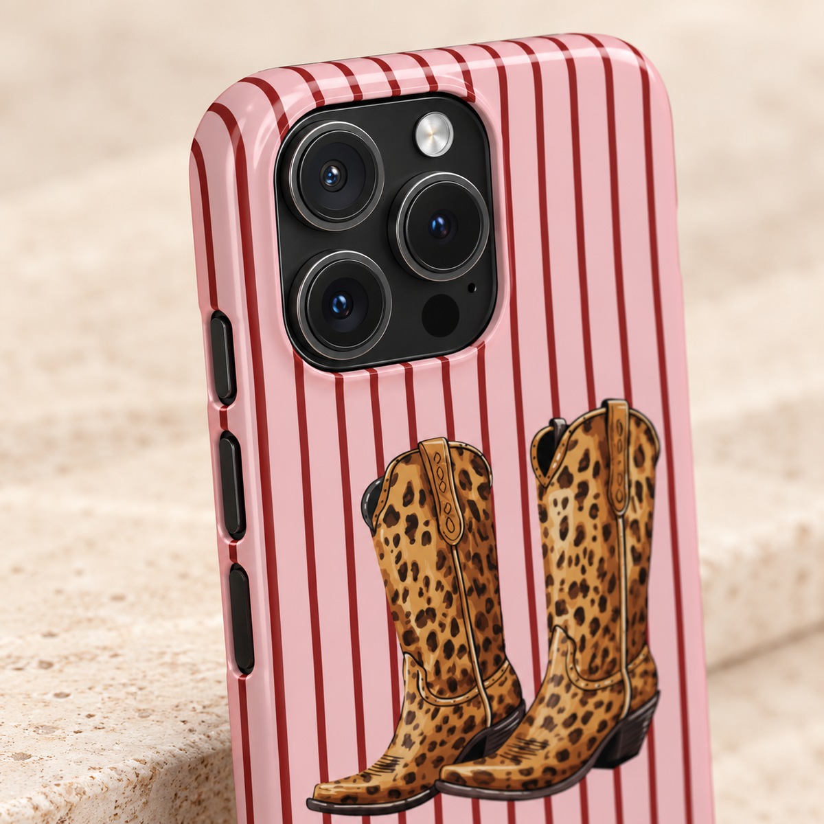 Cowgirl Boots protective phone case, leopard cowgirl boots on pink pinstripes, lifestyle close-up of the camera