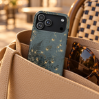 Enchanted Forest protective phone case, ferns and golden fairy lights on slate green, lifestyle photo in a handbag