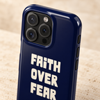 Faith Over Fear protective phone case, bold Faith Over Fear lettering on navy, lifestyle close-up of the camera