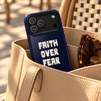 Faith Over Fear MagSafe case, bold Faith Over Fear lettering on navy, lifestyle photo in a handbag