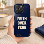 Faith Over Fear phone case with card holder, bold Faith Over Fear lettering on navy, lifestyle photo in hand with coffee