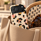 Golden Leopard phone case with card holder, leopard spots with gold flecks on cream, lifestyle photo in a handbag