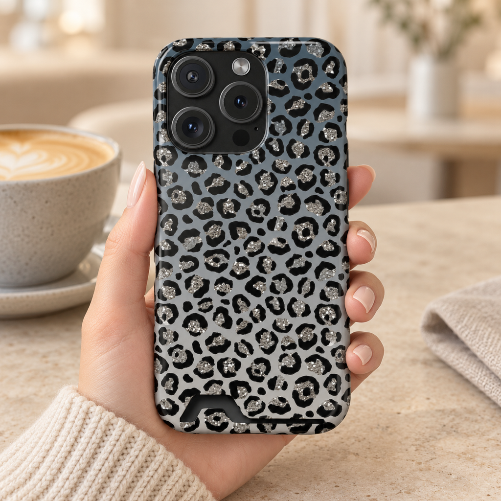 Gray Leopard phone case with card holder, black leopard spots on soft gray, lifestyle photo in hand with coffee