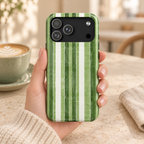 Green Stripe protective phone case, painted green and white stripes, lifestyle photo in hand with coffee