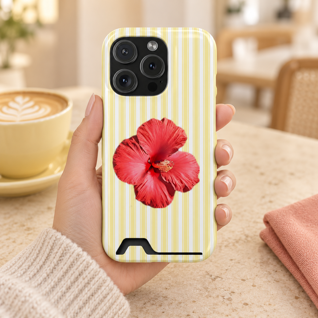 Hibiscus Stripe phone case with card holder, a red hibiscus on pale yellow stripes, lifestyle photo in hand with coffee