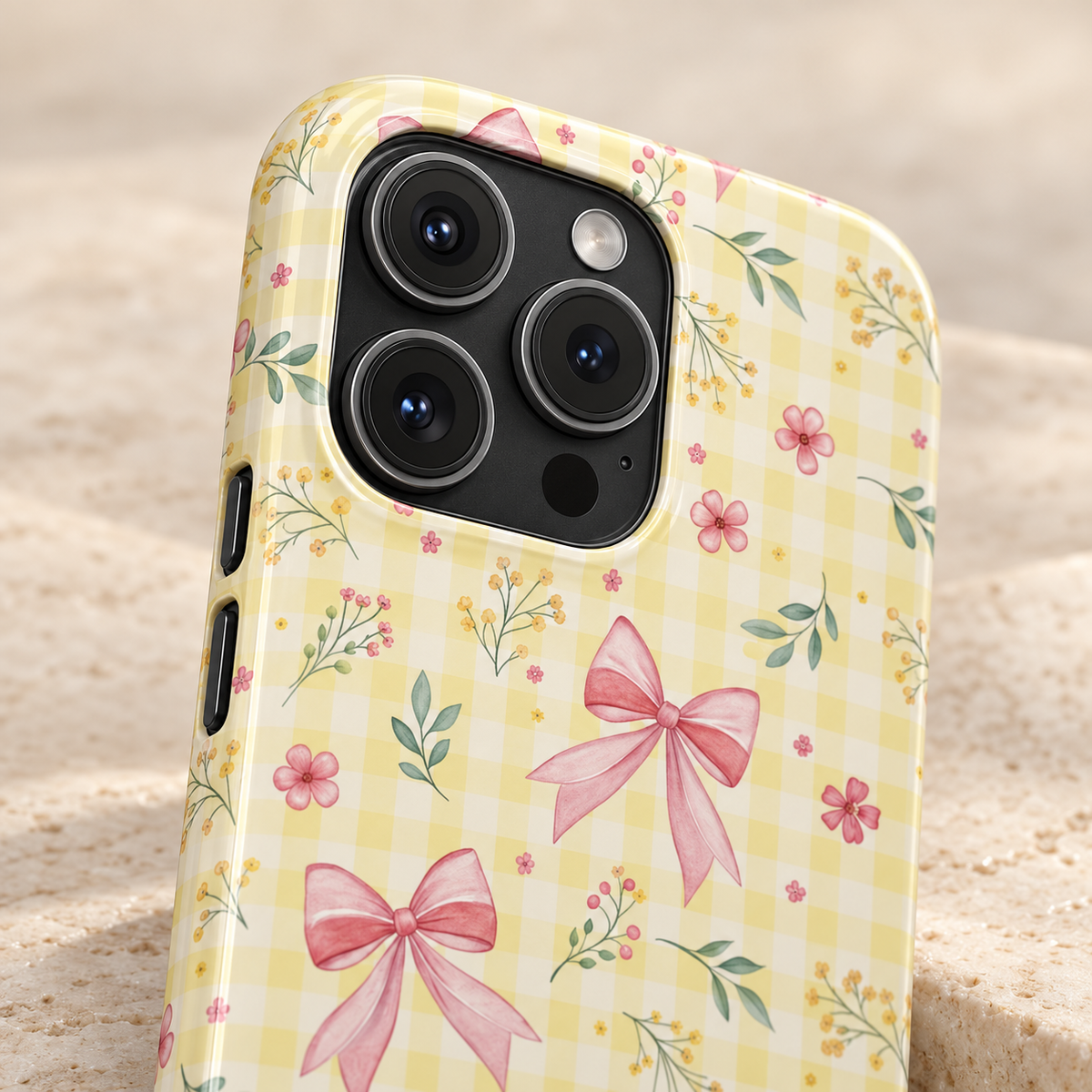 Lemon Bow Gingham protective phone case, pink bows and tiny flowers on lemon gingham, lifestyle close-up of the camera