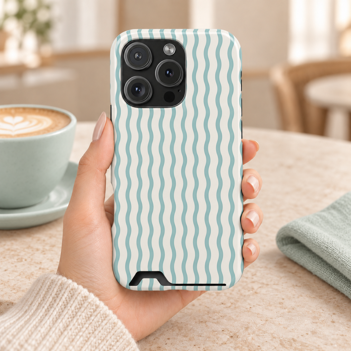 Mint Wave Stripe phone case with card holder, wavy mint green stripes on white, lifestyle photo in hand with coffee