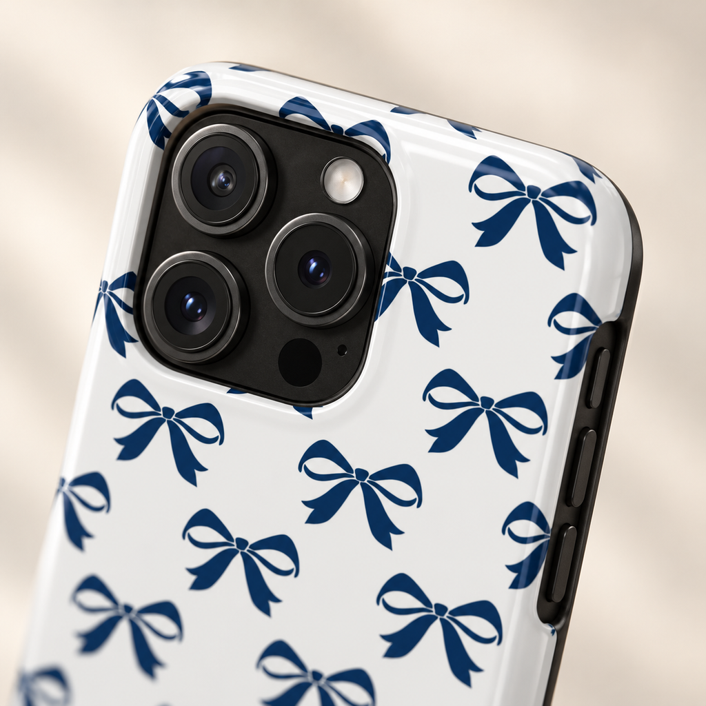 Navy Bow protective phone case, navy ribbon bows on white, lifestyle close-up of the camera