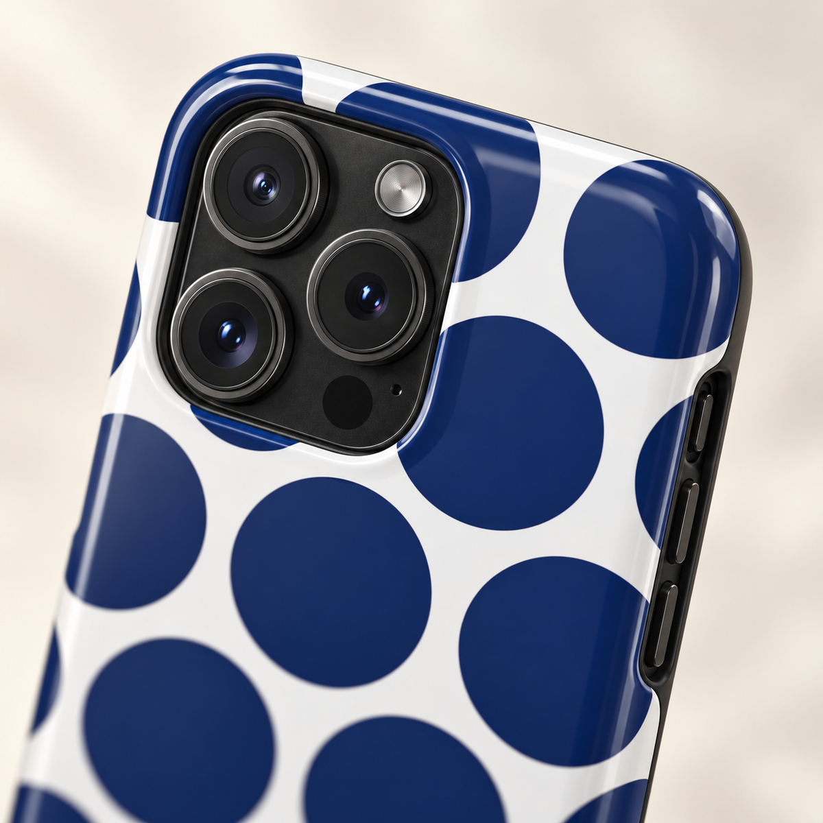 Navy Polka Dot MagSafe case, big navy polka dots on white, lifestyle close-up of the camera