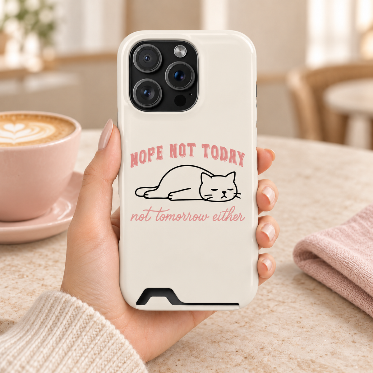 Nope Not Today phone case with card holder, a lazy cat with Nope Not Today lettering on cream, lifestyle photo in hand with coffee