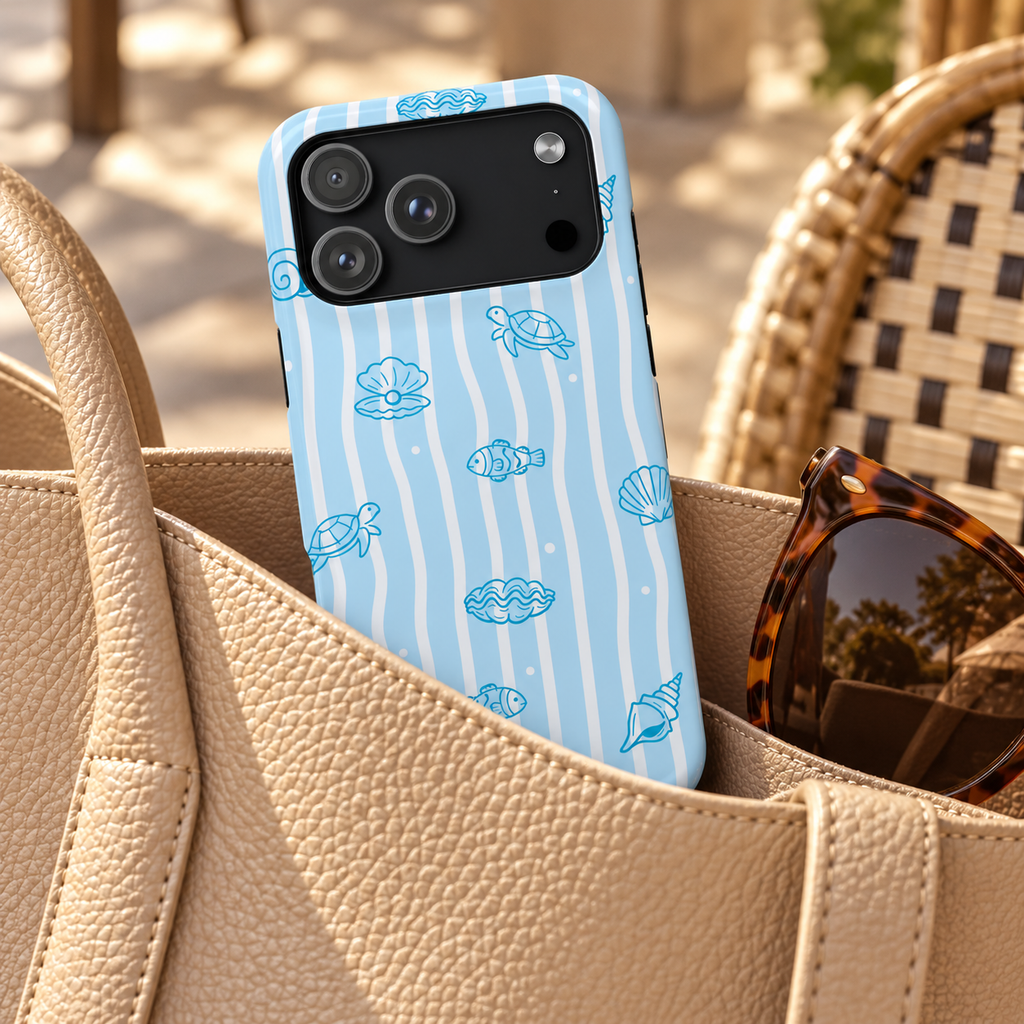 Ocean Doodle Stripe protective phone case, seashell and turtle doodles on wavy blue stripes, lifestyle photo in a handbag
