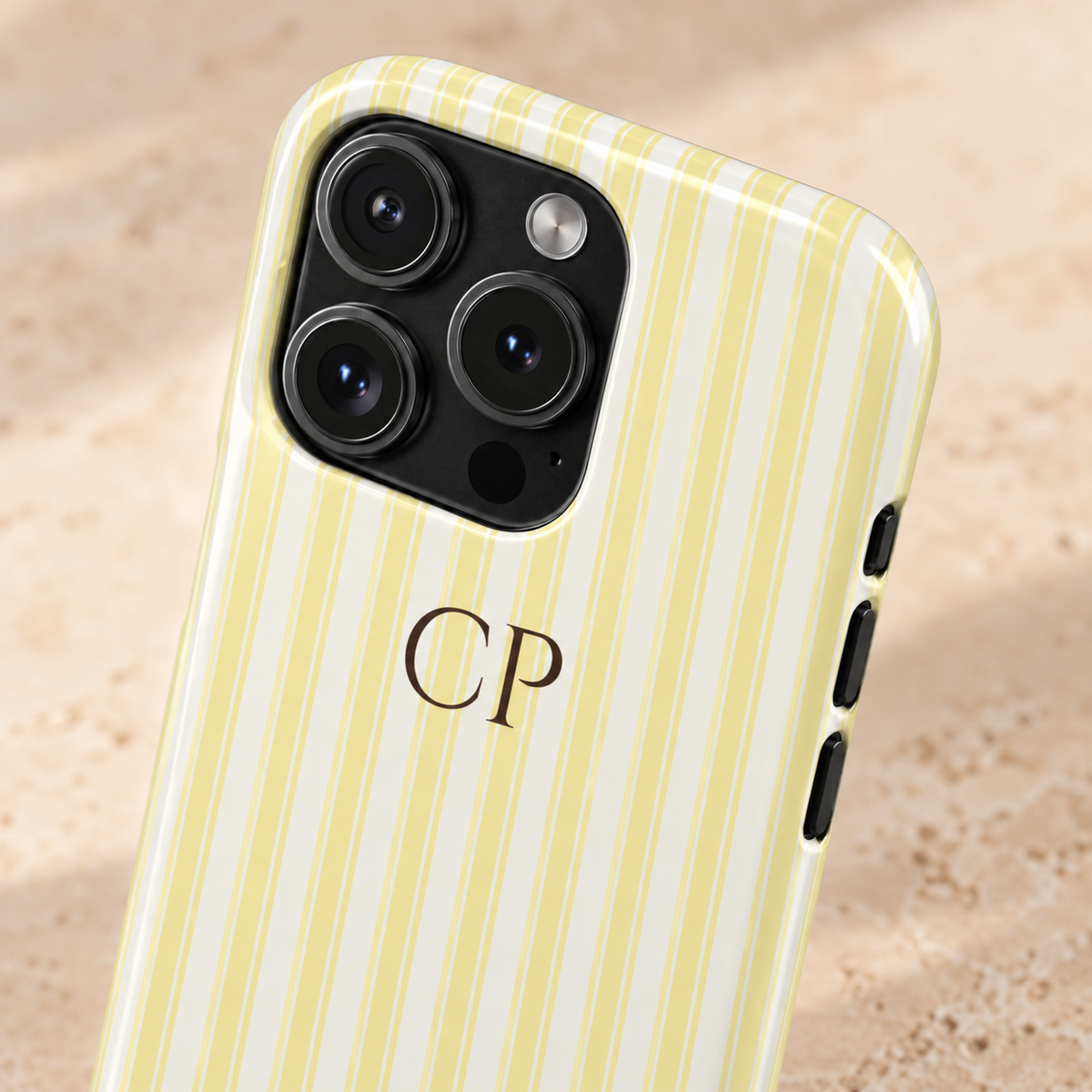 Cream Stripe Monogram personalized protective phone case, cream and pale yellow stripes with a serif monogram, lifestyle close-up of the camera