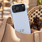Sky Pinstripe Monogram personalized MagSafe case, sky blue pinstripes with a gold serif monogram, lifestyle photo in a handbag