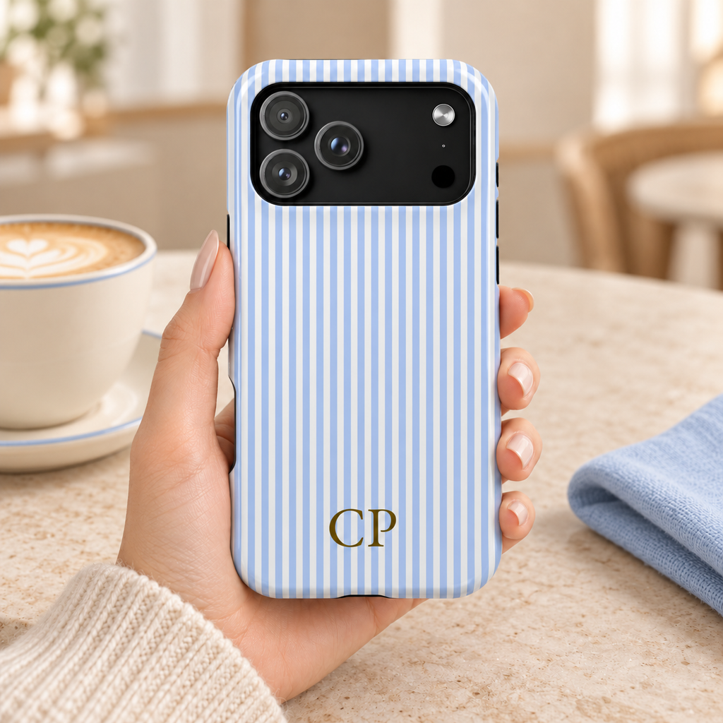 Sky Pinstripe Monogram personalized MagSafe case, sky blue pinstripes with a gold serif monogram, lifestyle photo in hand with coffee