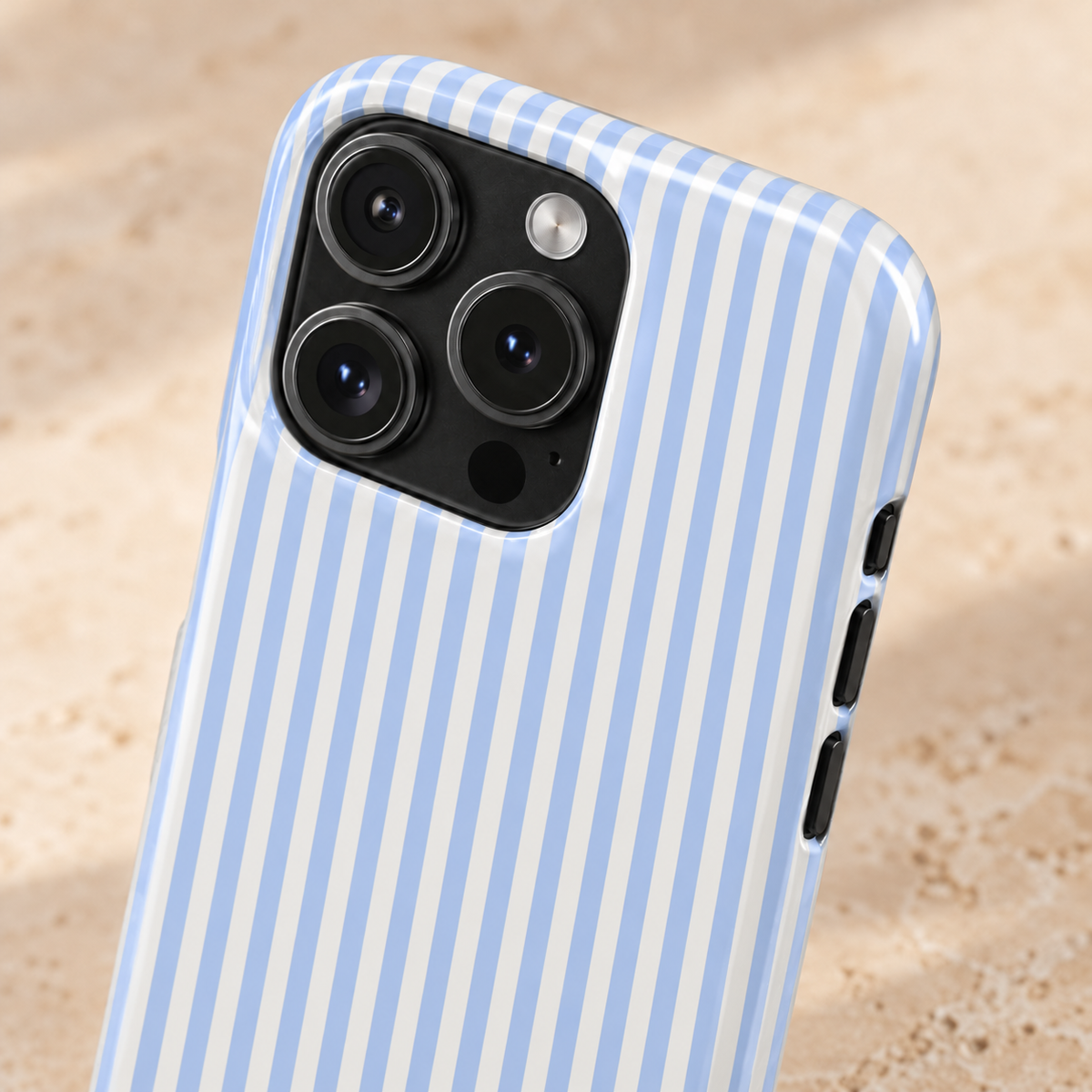 Sky Pinstripe Monogram personalized MagSafe case, sky blue pinstripes with a gold serif monogram, lifestyle close-up of the camera