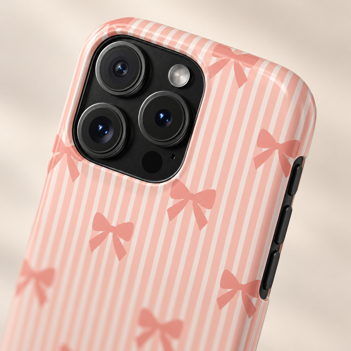 Peach Bow Stripe phone case with card holder, peach bows on soft peach stripes, lifestyle close-up of the camera