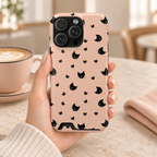 Peach Kitty phone case with card holder, little black cats on peach, lifestyle photo in hand with coffee