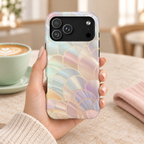 Pearl Scale MagSafe case, iridescent mother-of-pearl scales with gold lines, lifestyle photo in hand with coffee