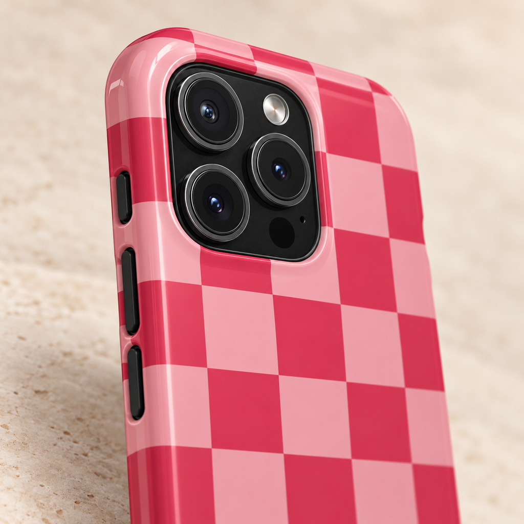 Pink Checkerboard protective phone case, a pink and raspberry checkerboard, lifestyle close-up of the camera