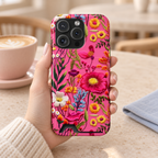 Pink Folk Floral phone case with card holder, bright folk-style flowers on hot pink, lifestyle photo in hand with coffee