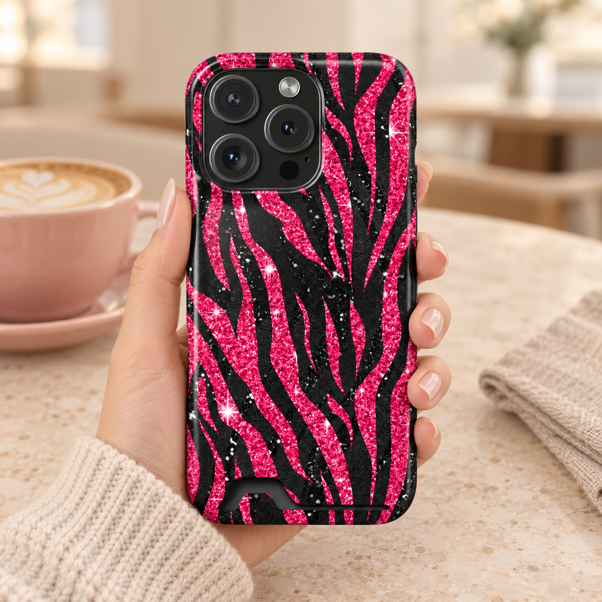 Pink Glitter Zebra phone case with card holder, hot pink glitter zebra stripes on black, lifestyle photo in hand with coffee