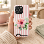 Pink Hibiscus phone case with card holder, a pink hibiscus on blush stripes, lifestyle photo in hand with coffee