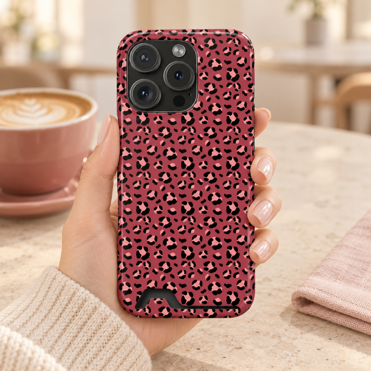 Pink Leopard phone case with card holder, blush leopard spots on raspberry, lifestyle photo in hand with coffee