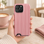 Pink Pinstripe phone case with card holder, black pinstripes on pink, lifestyle photo in hand with coffee